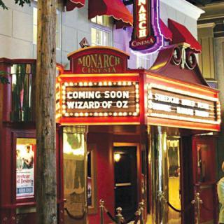 Theater marquee announcing 'Coming Soon: Wizard of Oz'.