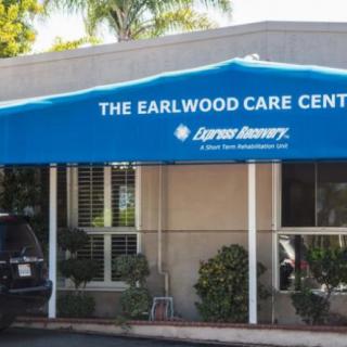 The entrance of The Earlwood Care Center with a blue awning.