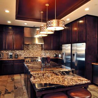 A luxurious modern kitchen with dark wood cabinets and granite countertops.