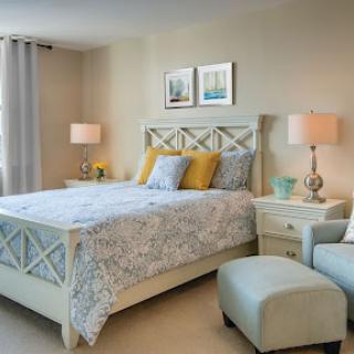 A beautifully designed modern bedroom featuring a cozy bed, stylish nightstands, and elegant decorative elements.