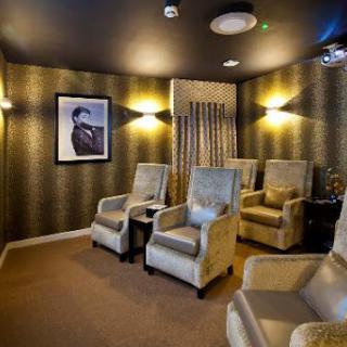 A cozy lounge area featuring comfortable upholstered chairs and ambient lighting, perfect for relaxation.