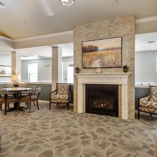 A cozy living room featuring a fireplace and comfortable seating area.