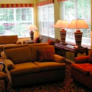A cozy living room with comfortable seating and ample natural light.