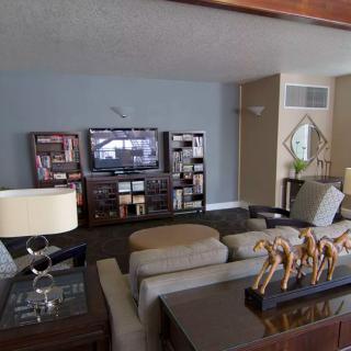 A cozy living room with a TV, modern furniture, and decorative elements.