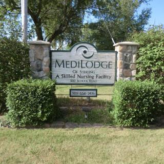 Entrance sign for MediLodge, a skilled nursing facility.