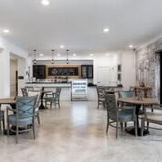Modern cafe dining area with tables and chairs.