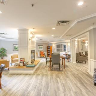 A spacious and modern living area with stylish furniture and warm lighting.