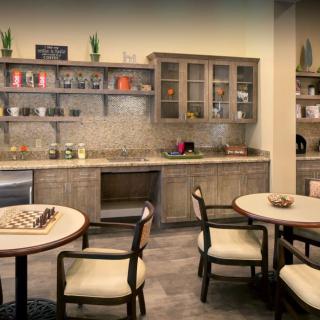 A cozy kitchen area with modern cabinets and seating arrangements.