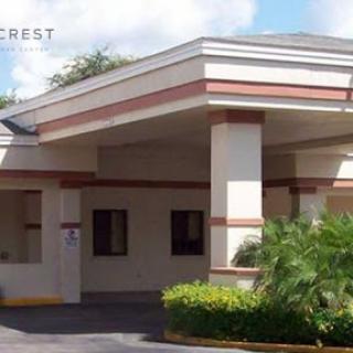 Exterior view of a hotel entrance surrounded by lush greenery.