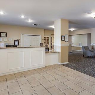 Spacious reception area with tiled flooring and comfortable seating.