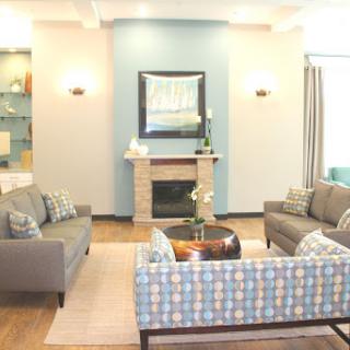 A beautifully designed modern living room featuring comfortable seating and a warm, inviting ambiance.