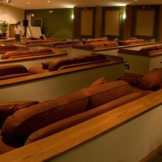 A cozy theater setup with rows of couches for comfortable viewing.