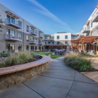 A modern apartment complex with a landscaped courtyard.