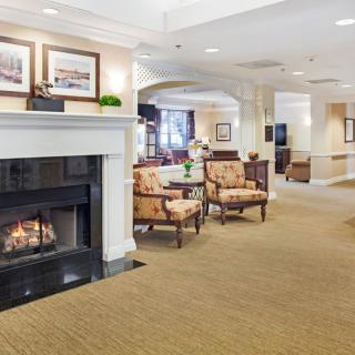 A cozy lounge area with a fireplace and comfortable seating.