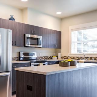 A modern kitchen with stainless steel appliances and a sleek design.