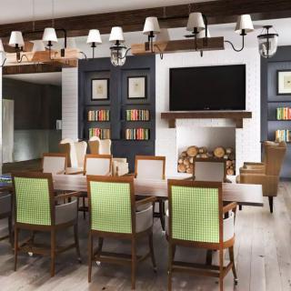 A modern dining room with elegant furnishings and a cozy fireplace.