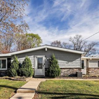 A charming single-family home featuring a modern exterior and well-maintained yard.