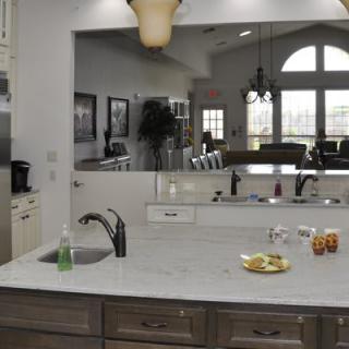 A modern kitchen with a marble countertop and stylish lighting.