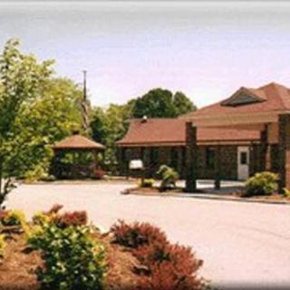 A scenic view of a building surrounded by trees and landscaping.
