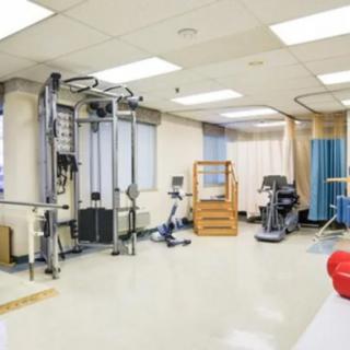 A well-equipped gym area in a healthcare or rehabilitation facility.