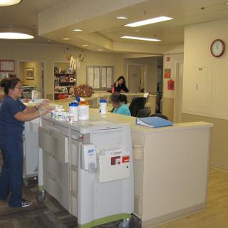 Nurses working at a hospital nurse station.