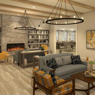 A modern and cozy living room with a fireplace and elegant chandeliers.