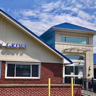 A modern commercial building featuring a blue roof and prominent signage.