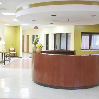 A modern reception area with a circular desk and seating.