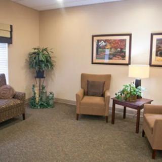 A cozy waiting room with armchairs and decor.