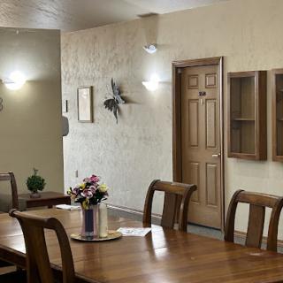 A cozy dining room featuring a wooden table, stylish decor, and warm lighting.