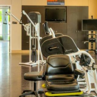 A well-equipped gym with various exercise machines for workouts.