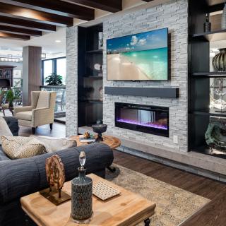 A modern living room featuring a sleek fireplace and a wall-mounted TV.