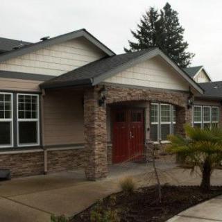 A residential house with stone accents and a landscaped entrance.