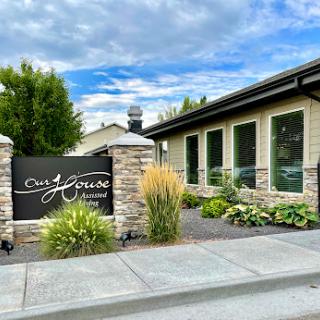 Entrance to a modern residential building with well-maintained landscaping.