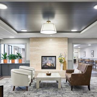 A modern living room with a central fireplace and stylish seating arrangement.