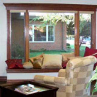 A cozy living room with a large window offering a view of the outside.