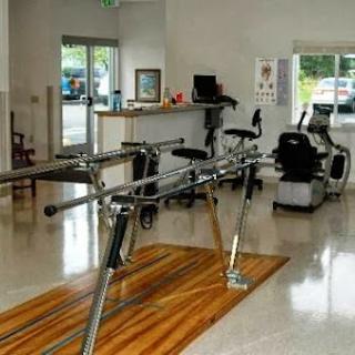 A well-equipped fitness area featuring exercise machines in a bright and spacious environment.