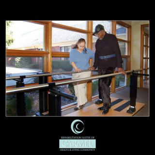 A person receiving assistance on balance bars during a physical therapy session.