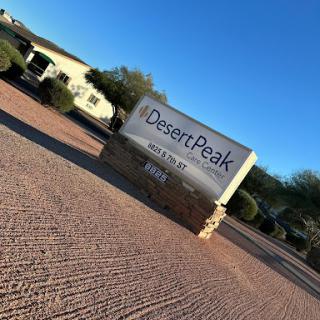 Signage for Desert Peak, set against a clear blue sky.