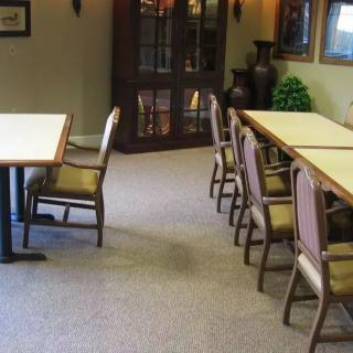 A quiet dining area with tables and chairs.
