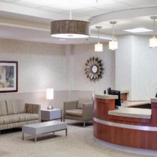 A modern reception area featuring comfortable seating and elegant lighting.