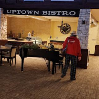 A quiet evening at the Uptown Bistro, featuring a grand piano and cozy seating.