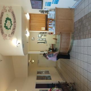 A hotel lobby with a reception desk and decorative wall art.