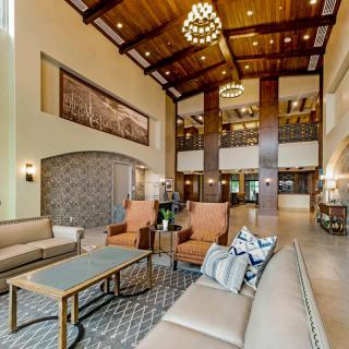 Spacious and elegantly designed hotel lobby with comfortable seating and warm lighting.