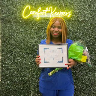 Celebrating a well-deserved achievement with a certificate and flowers!