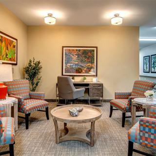 A cozy living room with modern furniture and decorative artwork.