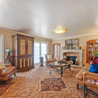 A cozy living room featuring elegant furniture and a warm fireplace.