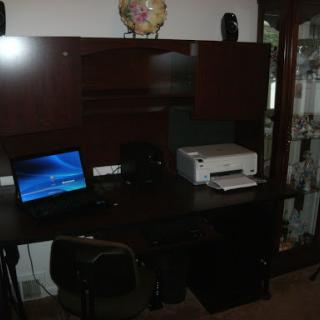 A cozy office setup featuring a desk with a computer and printer.