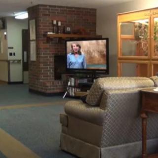 A cozy living room with a television and comfortable sofa.