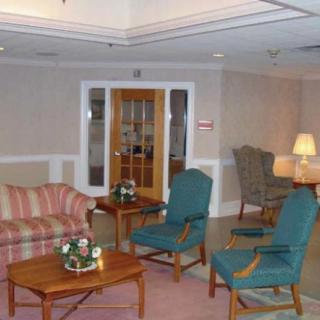 A cozy living room featuring a sofa, armchairs, and a coffee table.